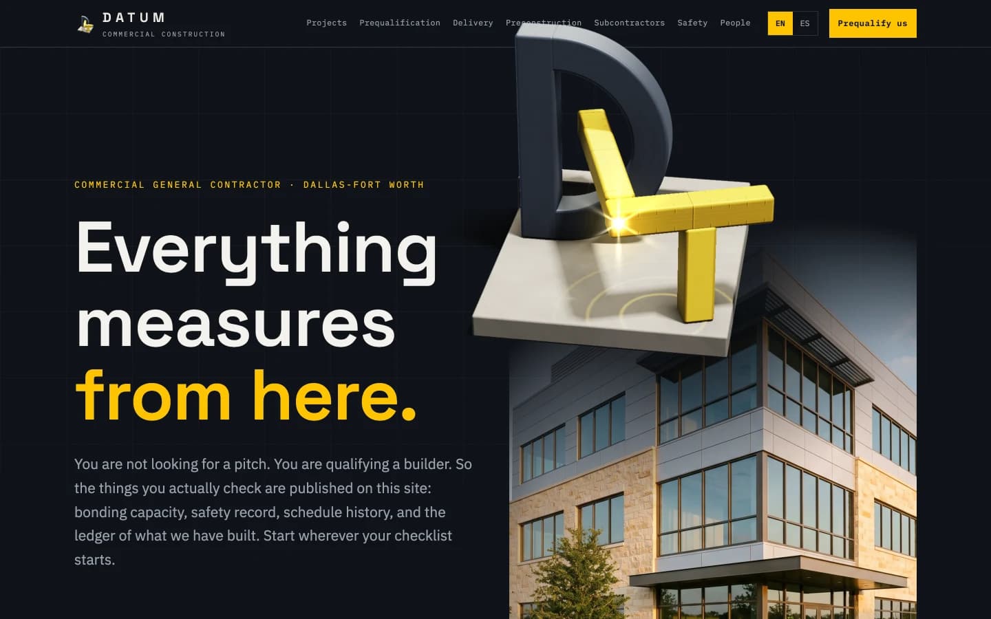 The Datum homepage hero: 'Everything measures from here.' in huge grotesk type over dark graphite, the last two words in safety yellow, above a mono kicker reading Commercial General Contractor, Dallas-Fort Worth, with a faint elevation grid behind the text and the datum-triangle mark in the nav.