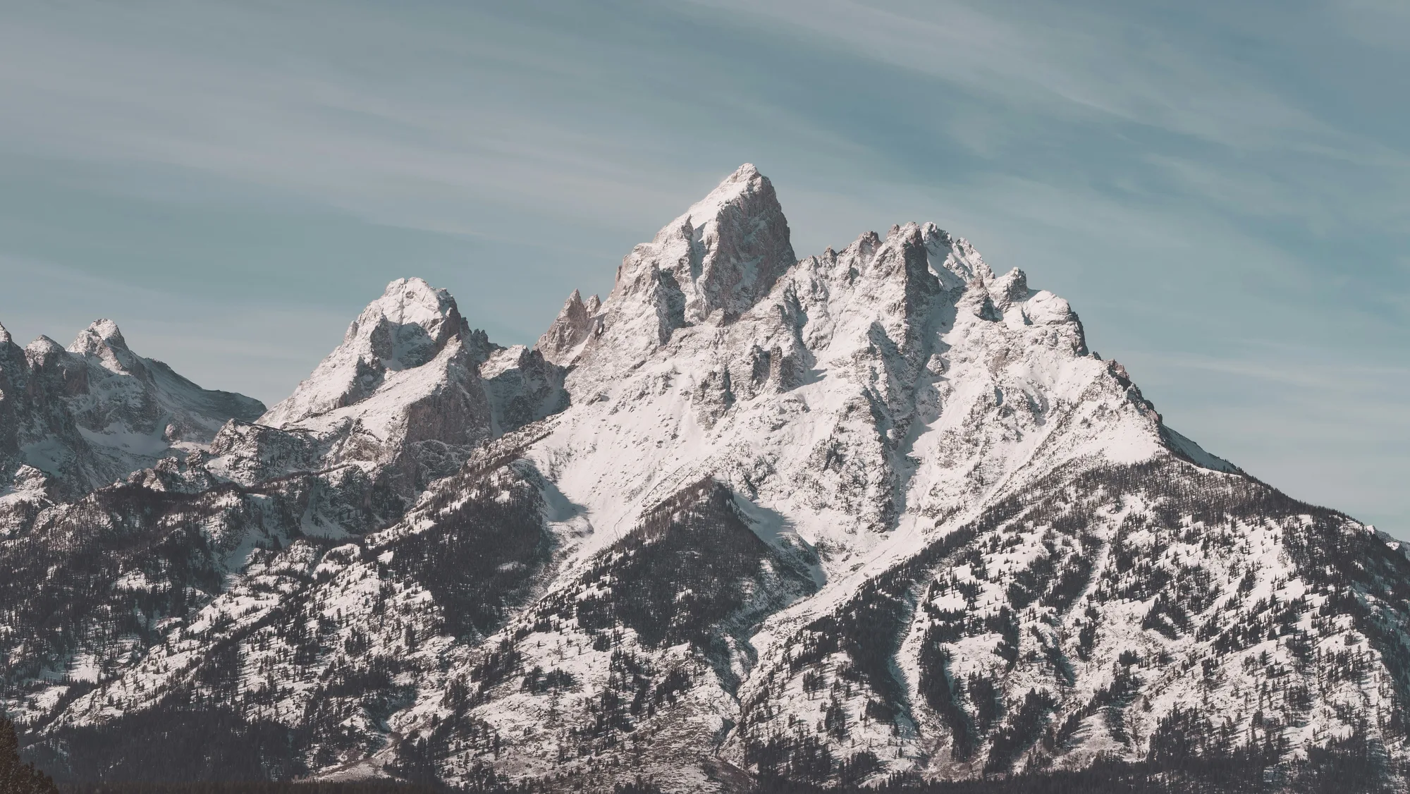 Snow-covered mountain peaks under a clear sky.