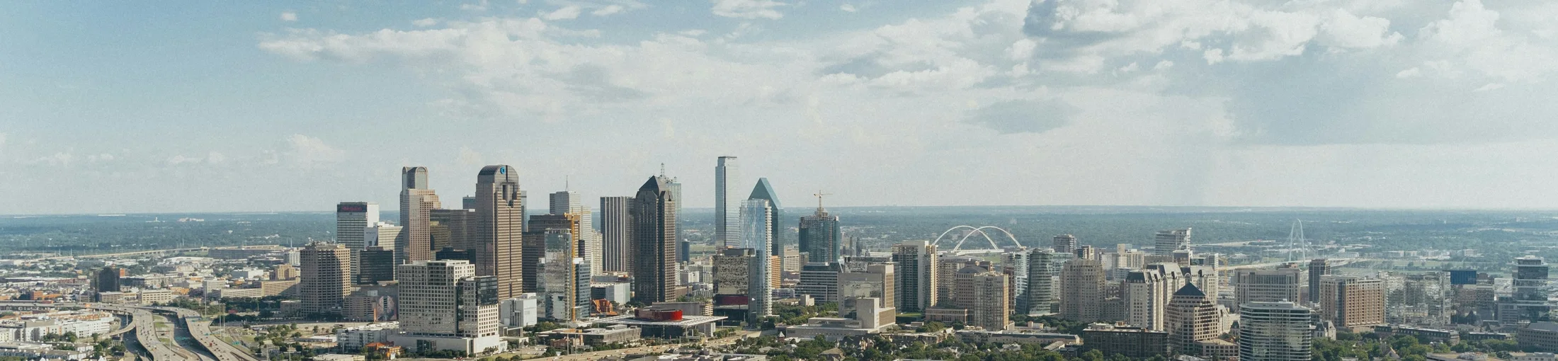 The downtown Dallas skyline under a clear Texas sky.