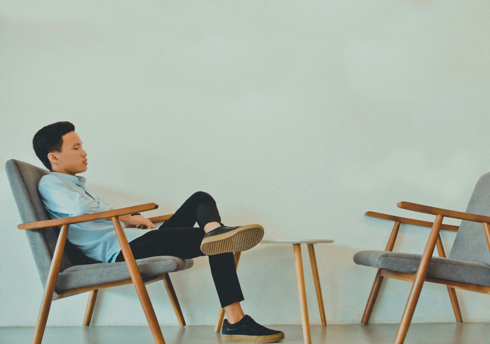 Two upholstered chairs arranged toward each other, the architectural symbol of the same chair experience at either office